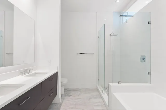 a bathroom with a shower sink vanity and a mirror