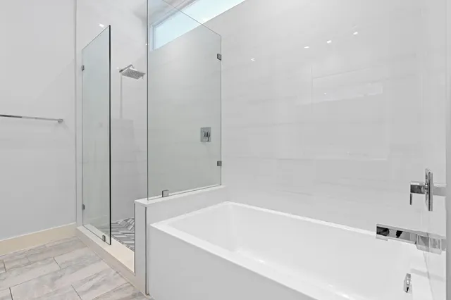 a bathroom with a bathtub and a shower
