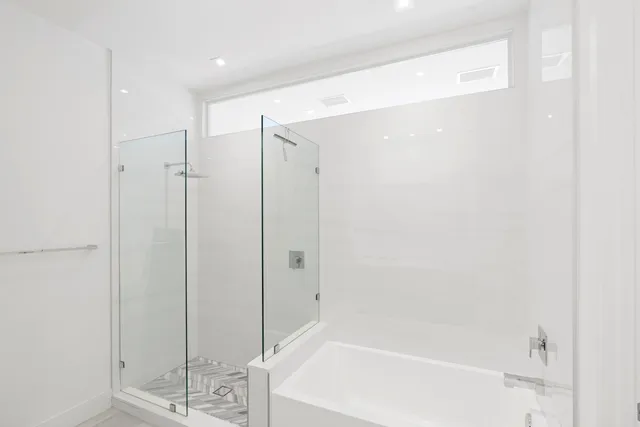 a bathroom with a bathtub and a shower