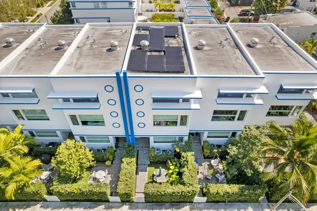 an aerial view of residential houses with city view