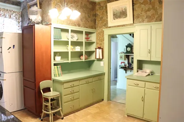 a kitchen with stainless steel appliances granite countertop a refrigerator a sink dishwasher a stove and white countertops with wooden floor