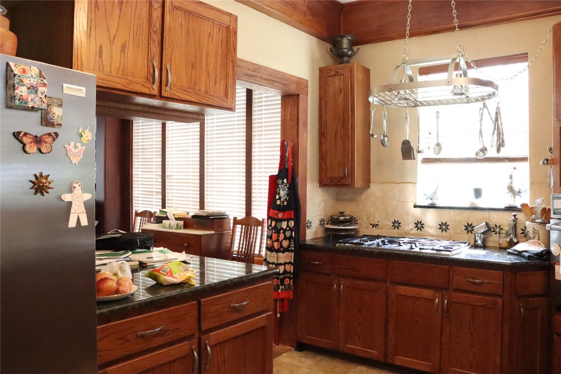 701 Sloan Street Taylor, TX 76574 - Photo 13 of 32 a kitchen with a sink cabinets and window