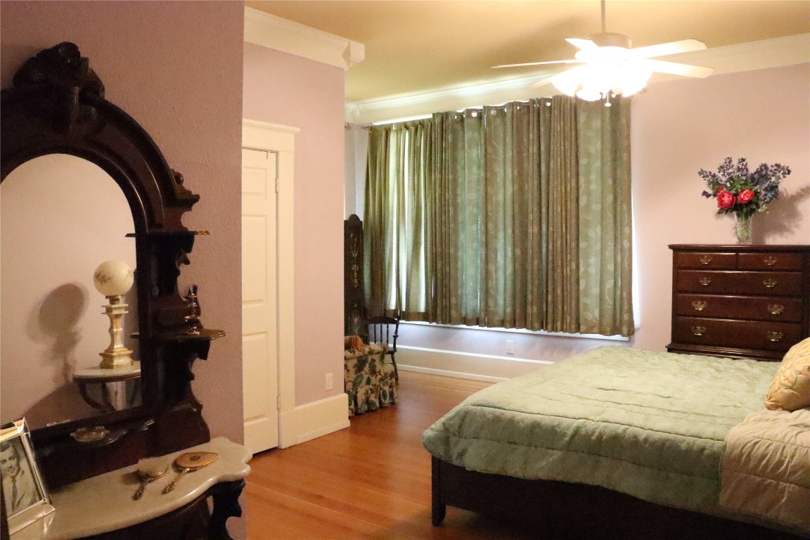 701 Sloan Street Taylor, TX 76574 - Photo 18 of 32 a spacious bedroom with a bed and a dresser