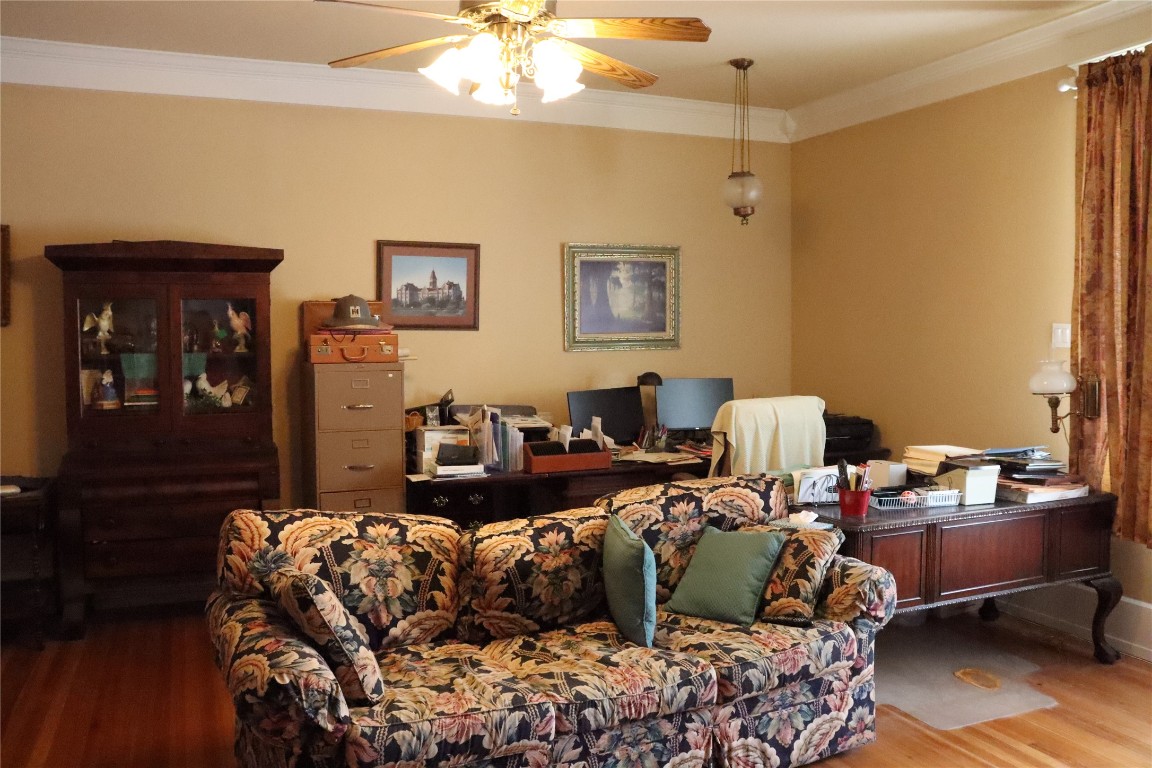 701 Sloan Street Taylor, TX 76574 - Photo 21 of 32 a living room with furniture and a chandelier