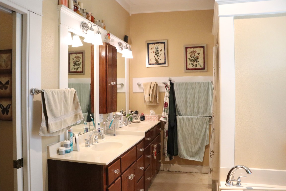 701 Sloan Street Taylor, TX 76574 - Photo 25 of 32 a bathroom with a sink vanity and a mirror