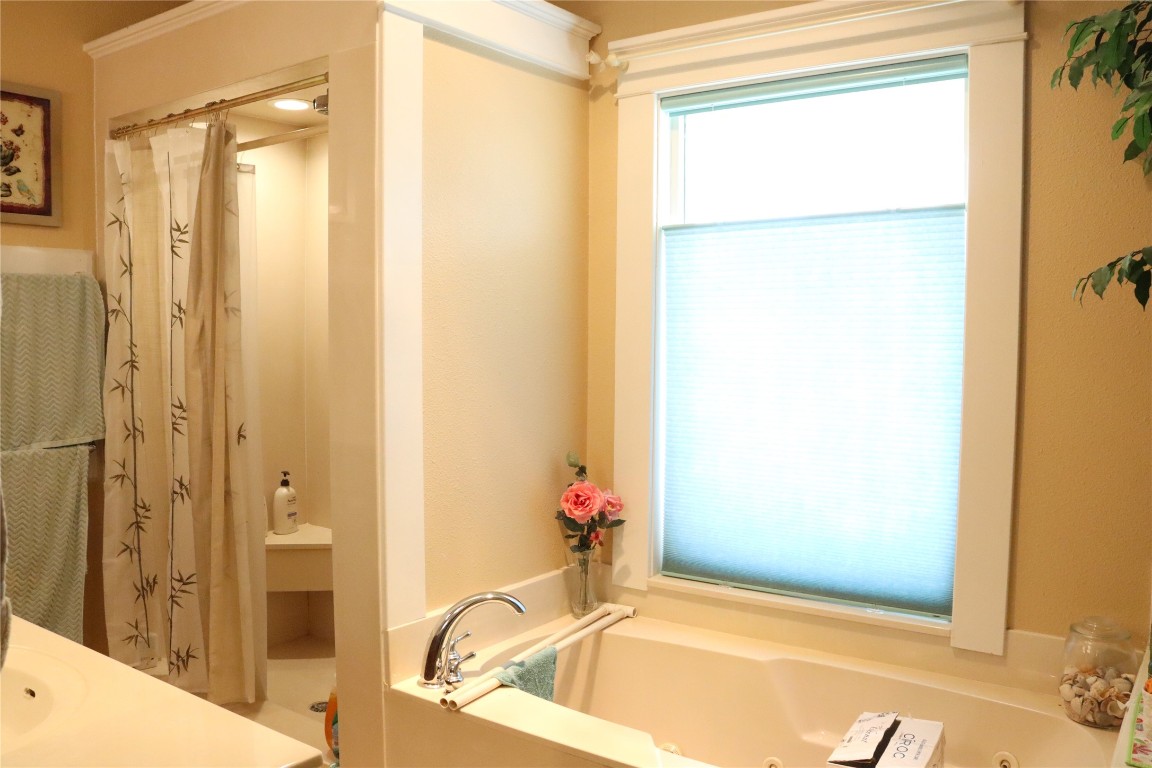701 Sloan Street Taylor, TX 76574 - Photo 26 of 32 a bathroom with a tub and shower