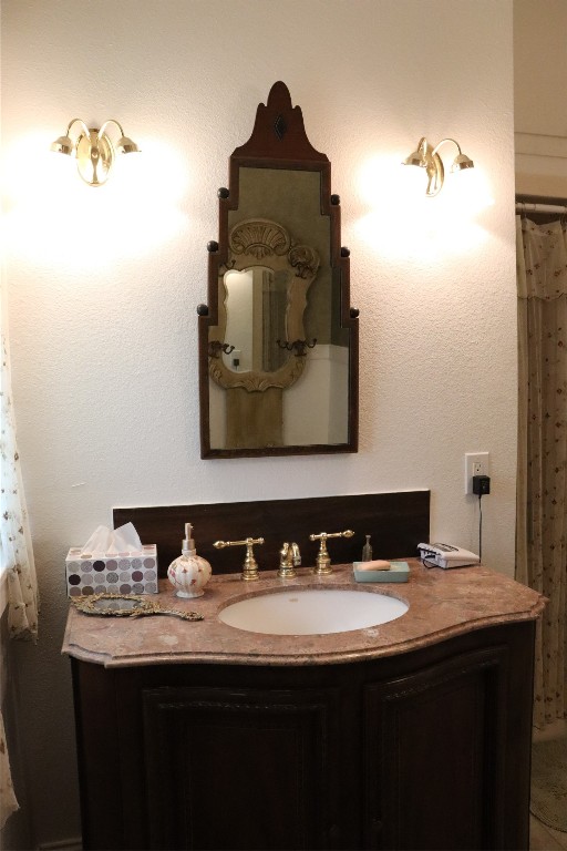 701 Sloan Street Taylor, TX 76574 - Photo 27 of 32 a bathroom with a sink and a mirror