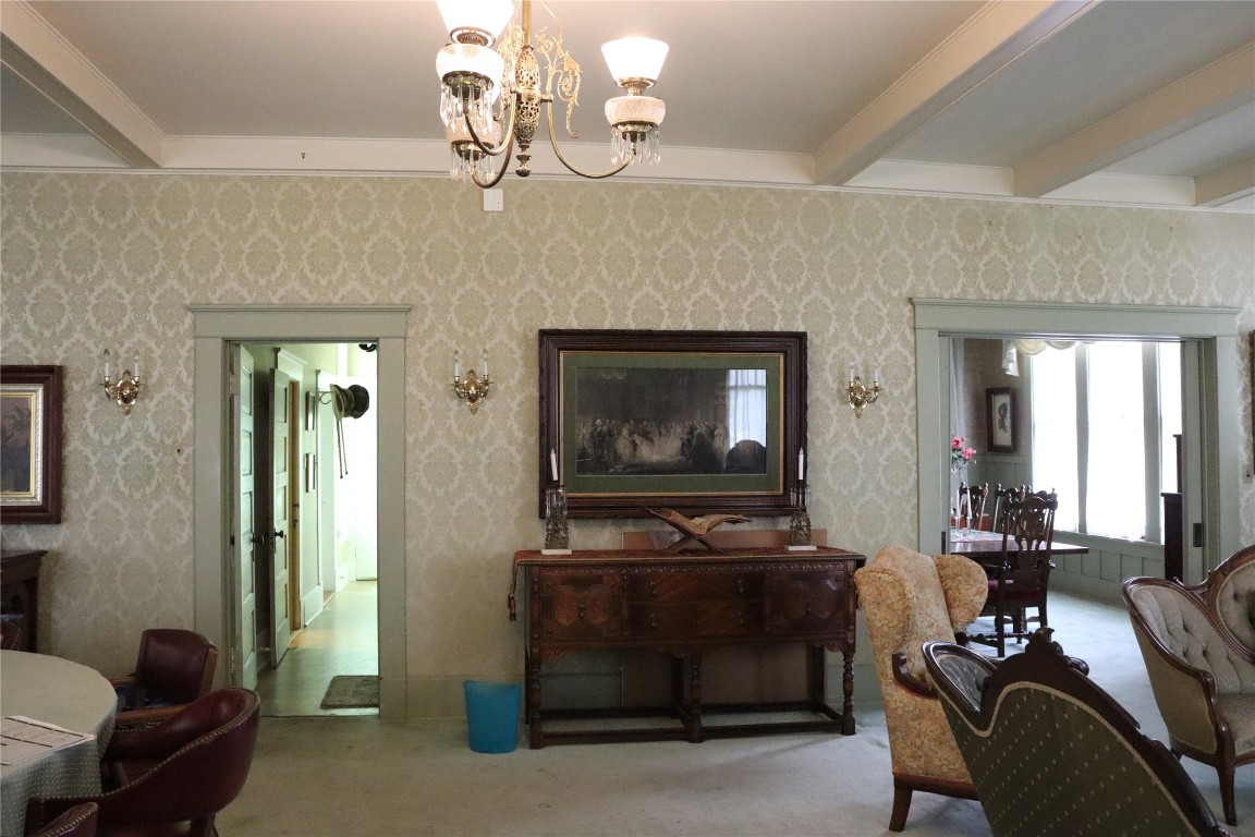 701 Sloan Street Taylor, TX 76574 - Photo 7 of 32 a living room with furniture a chandelier and a flat screen tv