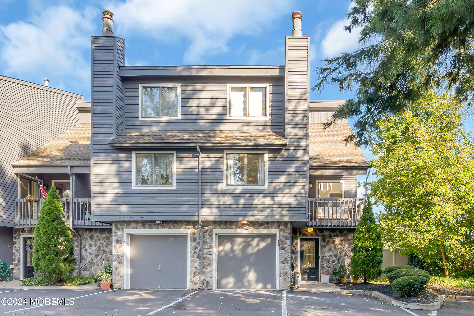 a front view of a house with a garden and plants