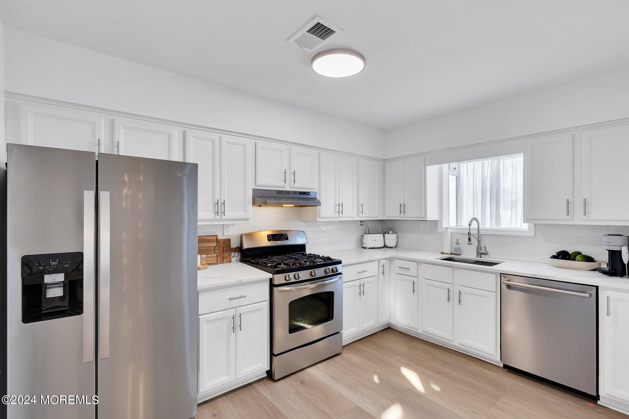 22 Devon Court Spring Lake Heights, NJ 07762 - Photo 11 of 54 a kitchen with white cabinets and white appliances
