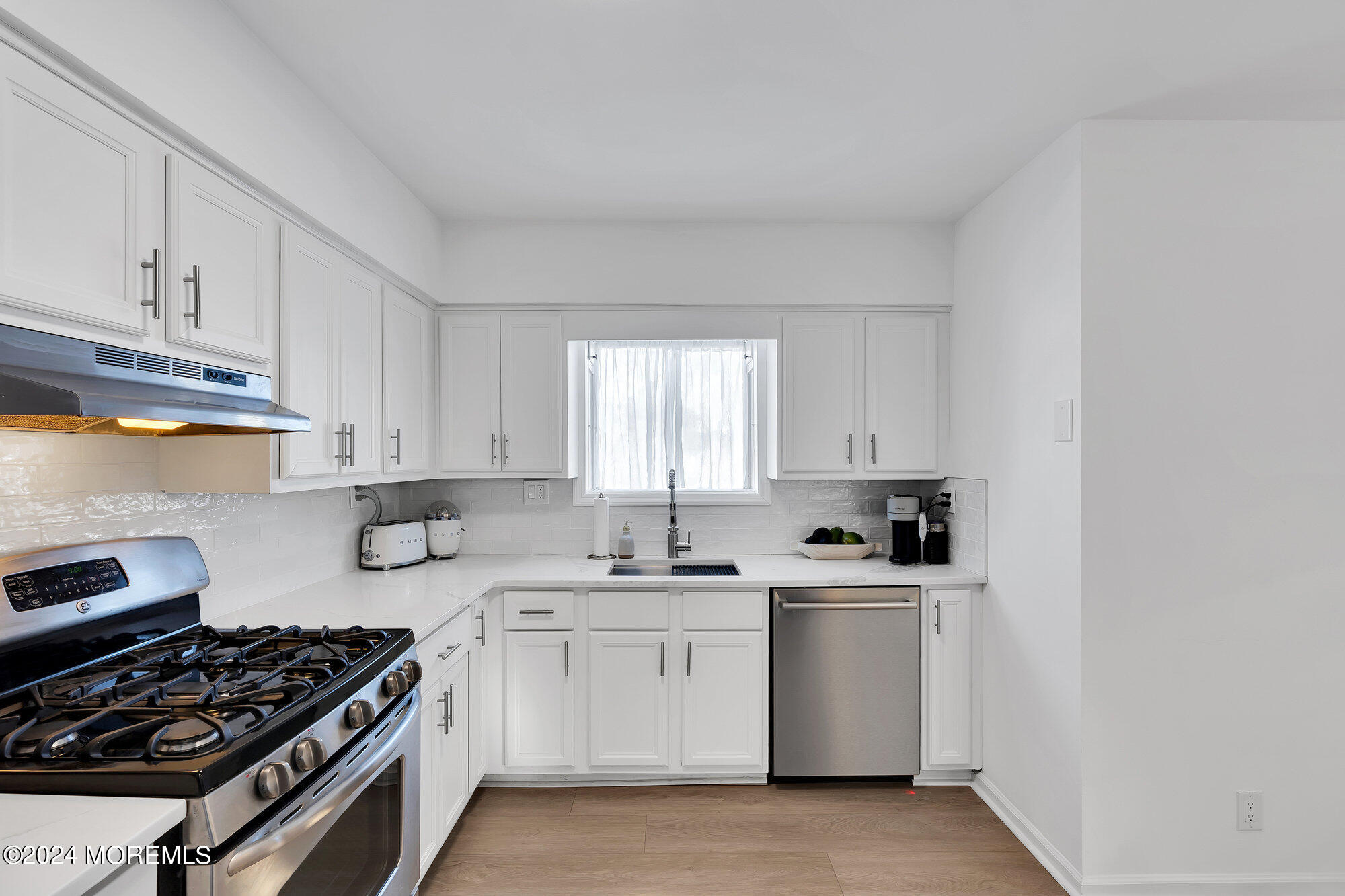 22 Devon Court Spring Lake Heights, NJ 07762 - Photo 14 of 54 a kitchen with a sink a stove and cabinets