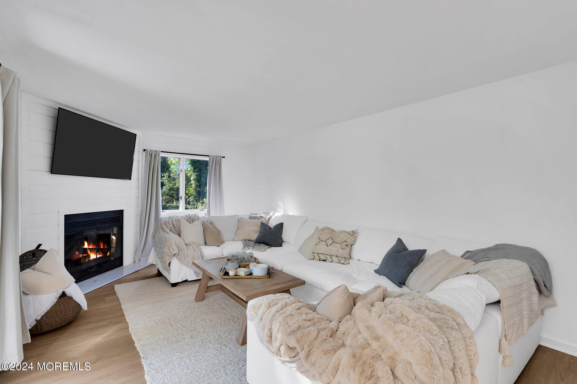 22 Devon Court Spring Lake Heights, NJ 07762 - Photo 27 of 54 a living room with furniture a fireplace and a flat screen tv