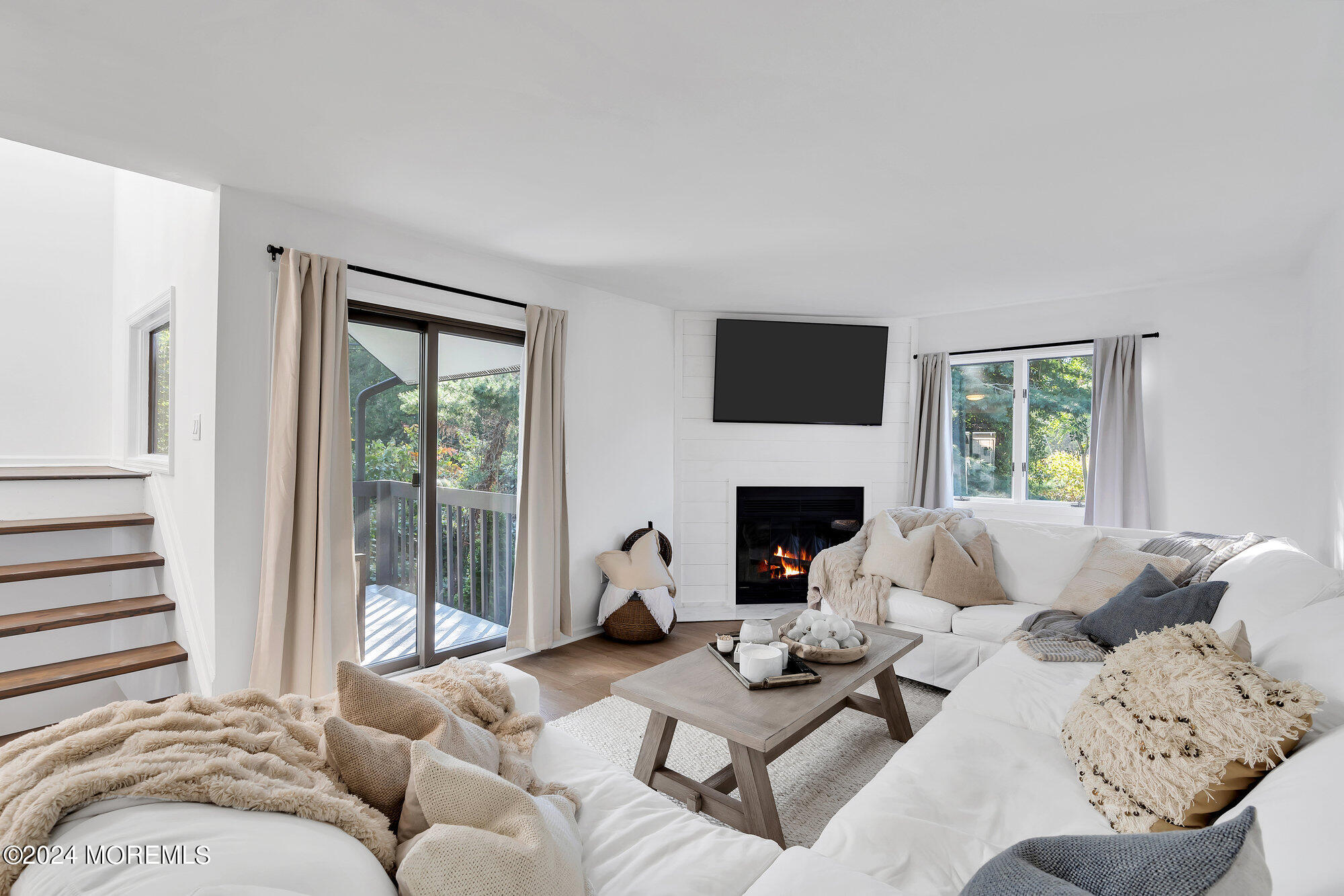22 Devon Court Spring Lake Heights, NJ 07762 - Photo 29 of 54 a living room with furniture a fireplace and a large window