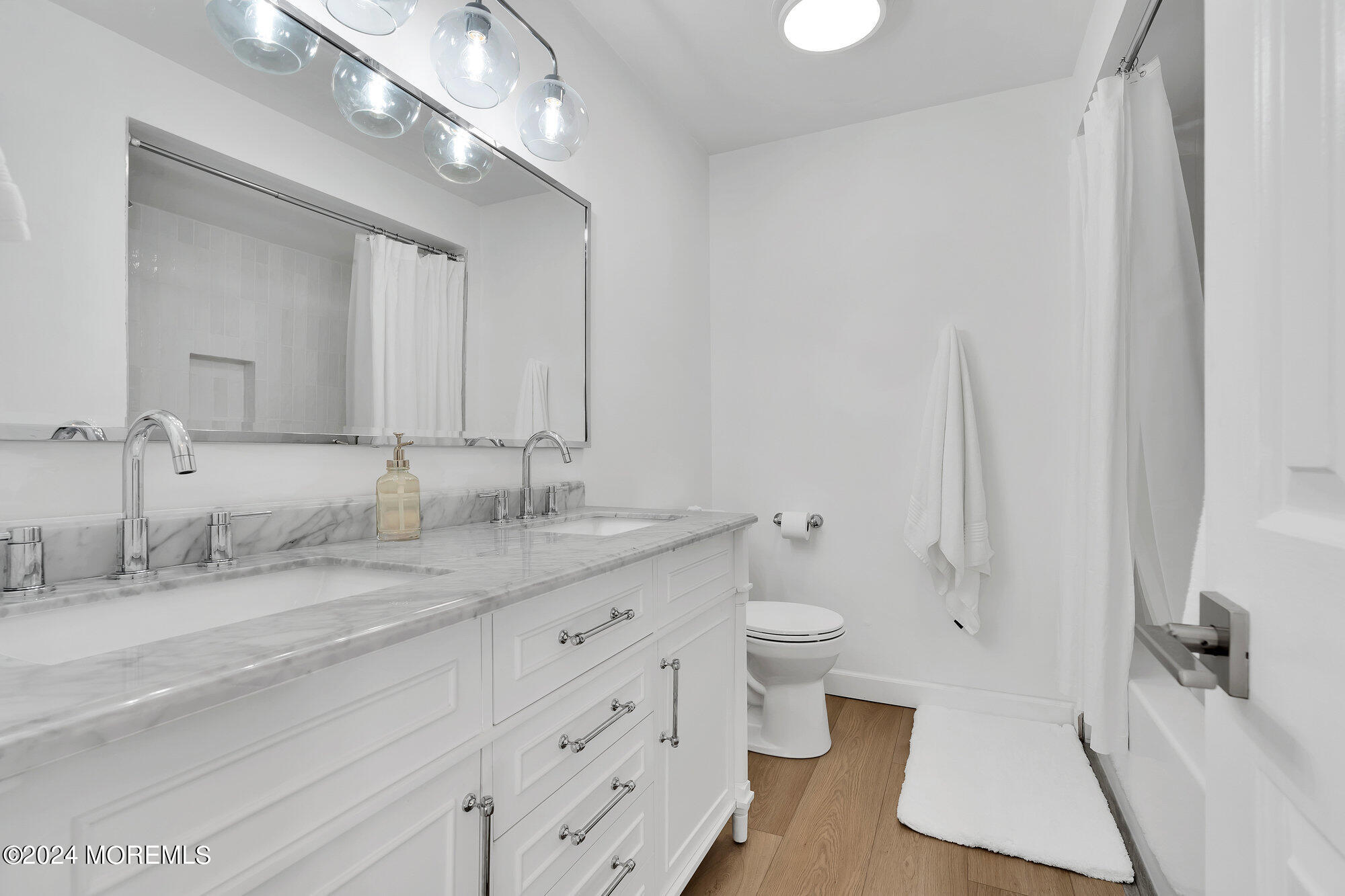 22 Devon Court Spring Lake Heights, NJ 07762 - Photo 41 of 54 a bathroom with a granite countertop sink a toilet and a mirror