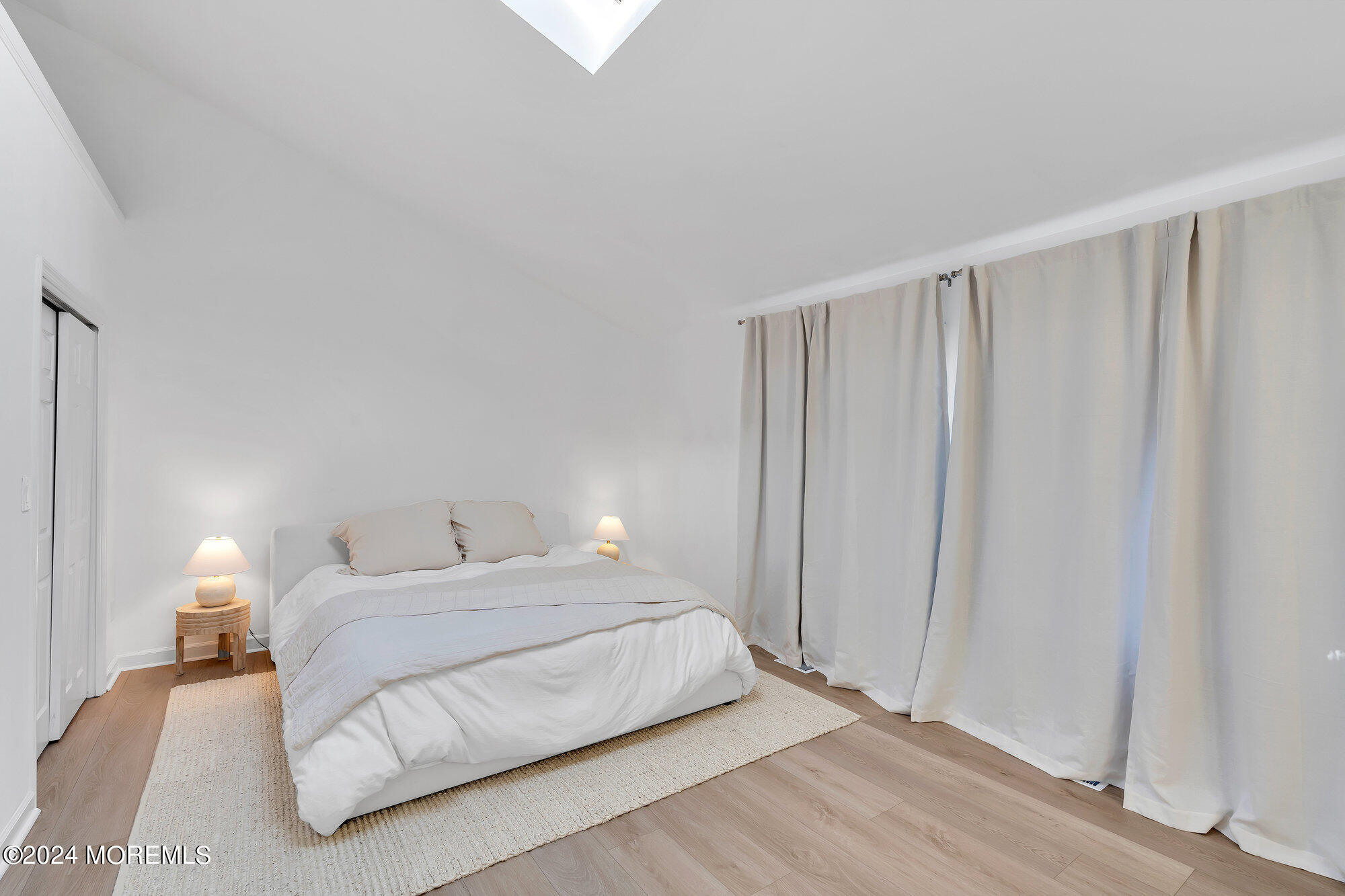 22 Devon Court Spring Lake Heights, NJ 07762 - Photo 44 of 54 a bedroom with a bed and a lamp with wooden floor