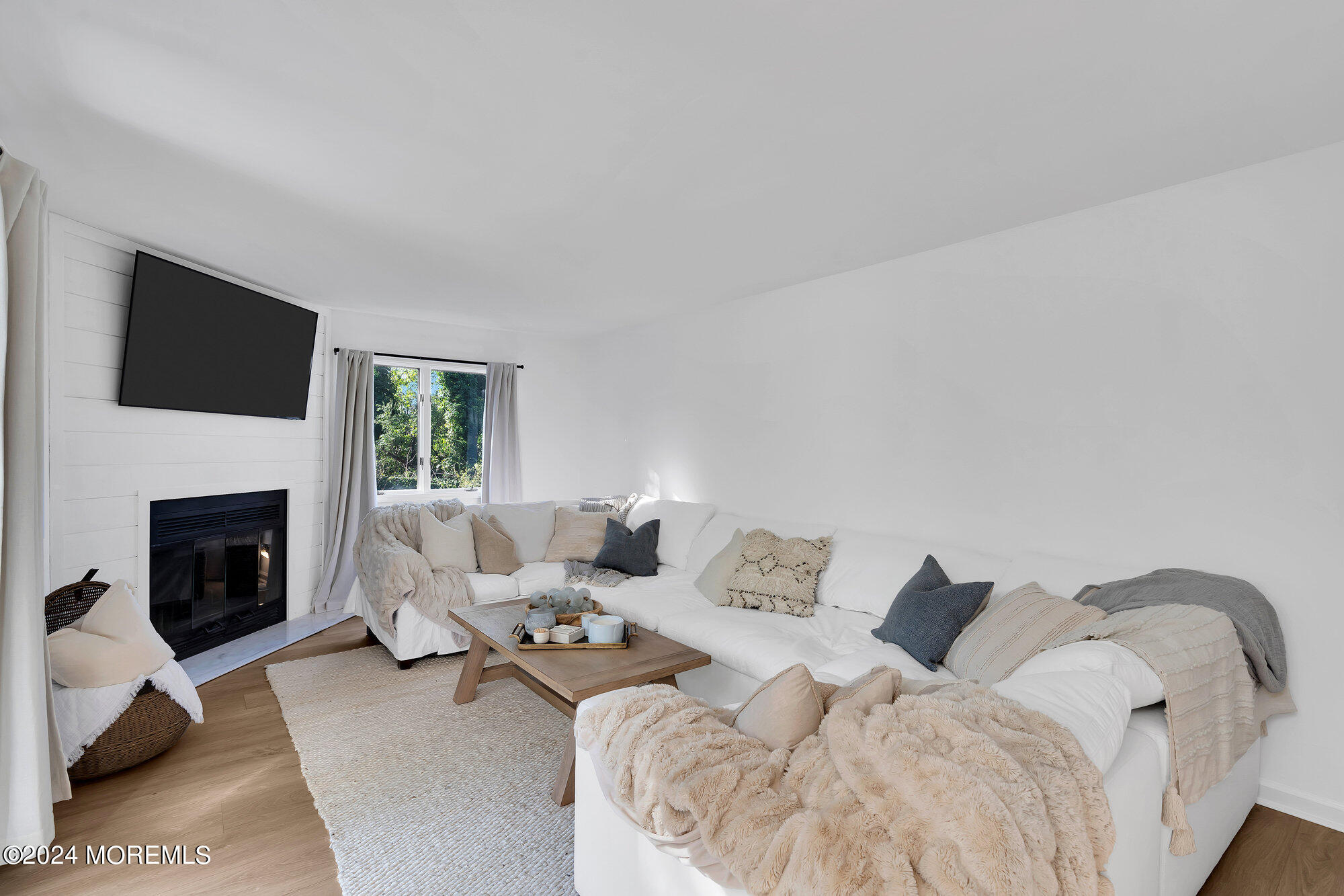 22 Devon Court Spring Lake Heights, NJ 07762 - Photo 51 of 54 a living room with furniture a fireplace and a flat screen tv