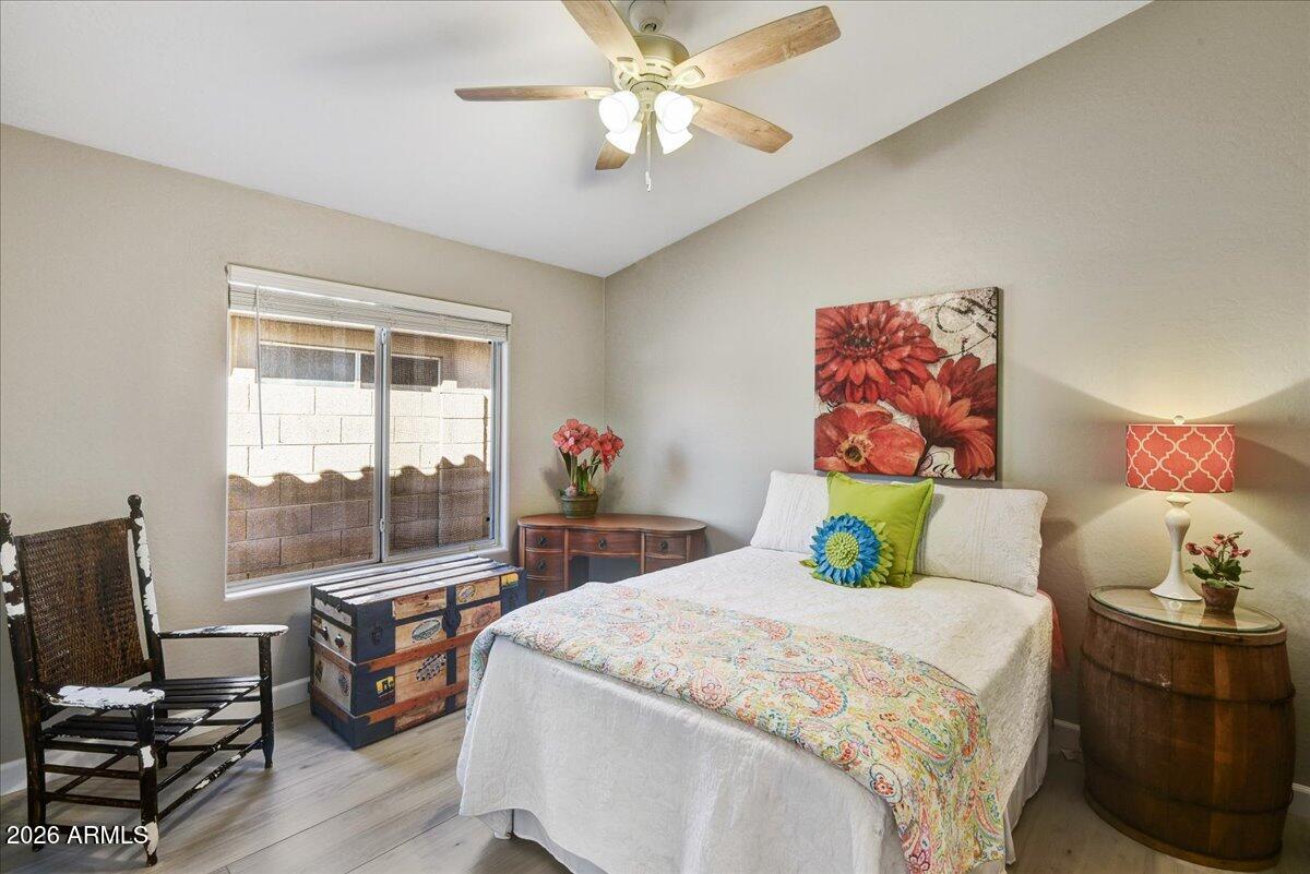 10830 West Almeria Road Avondale, AZ 85392 - Photo 11 of 27 a bedroom with a bed and large windows