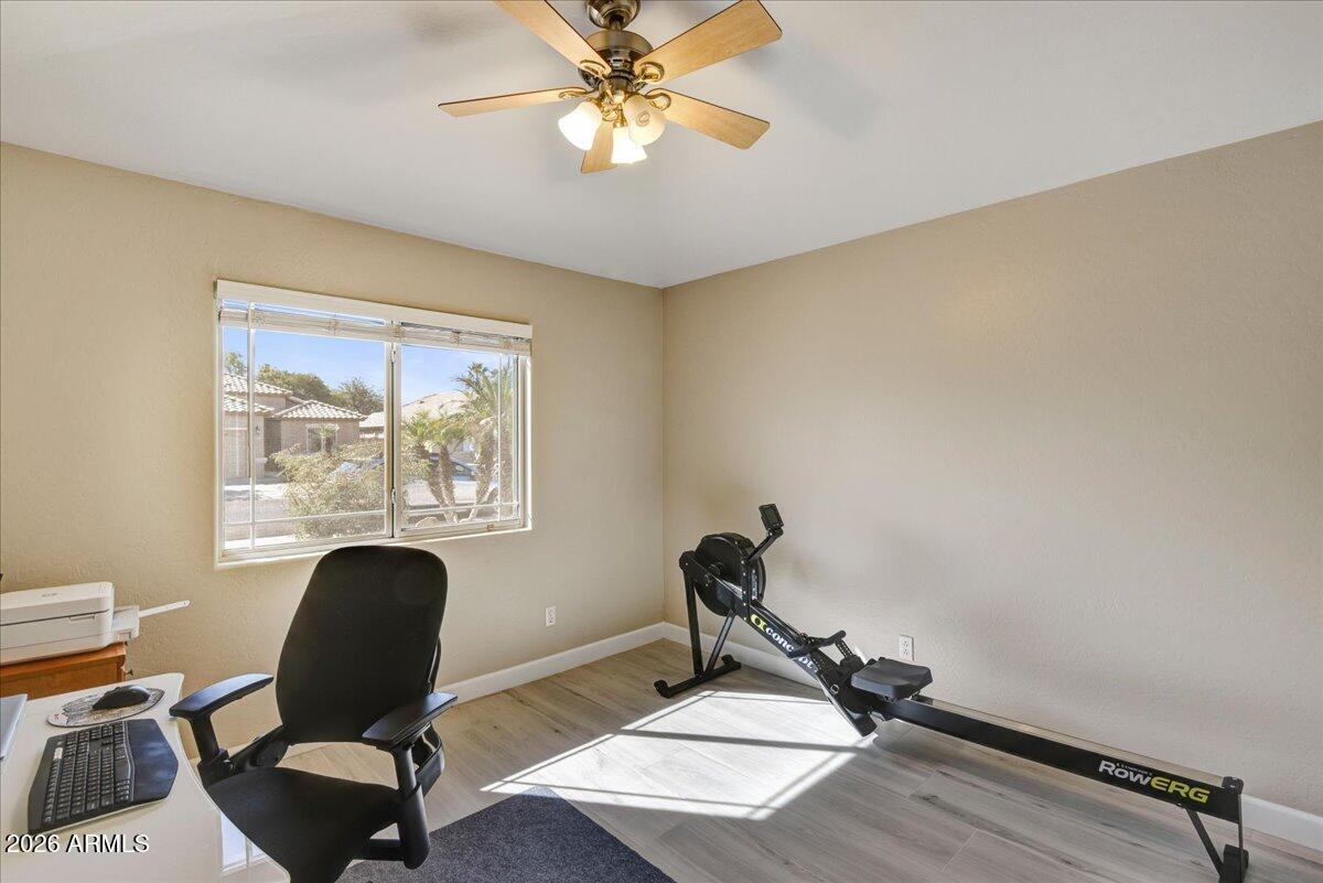 10830 West Almeria Road Avondale, AZ 85392 - Photo 13 of 27 a view of workspace with a window and gym equipment