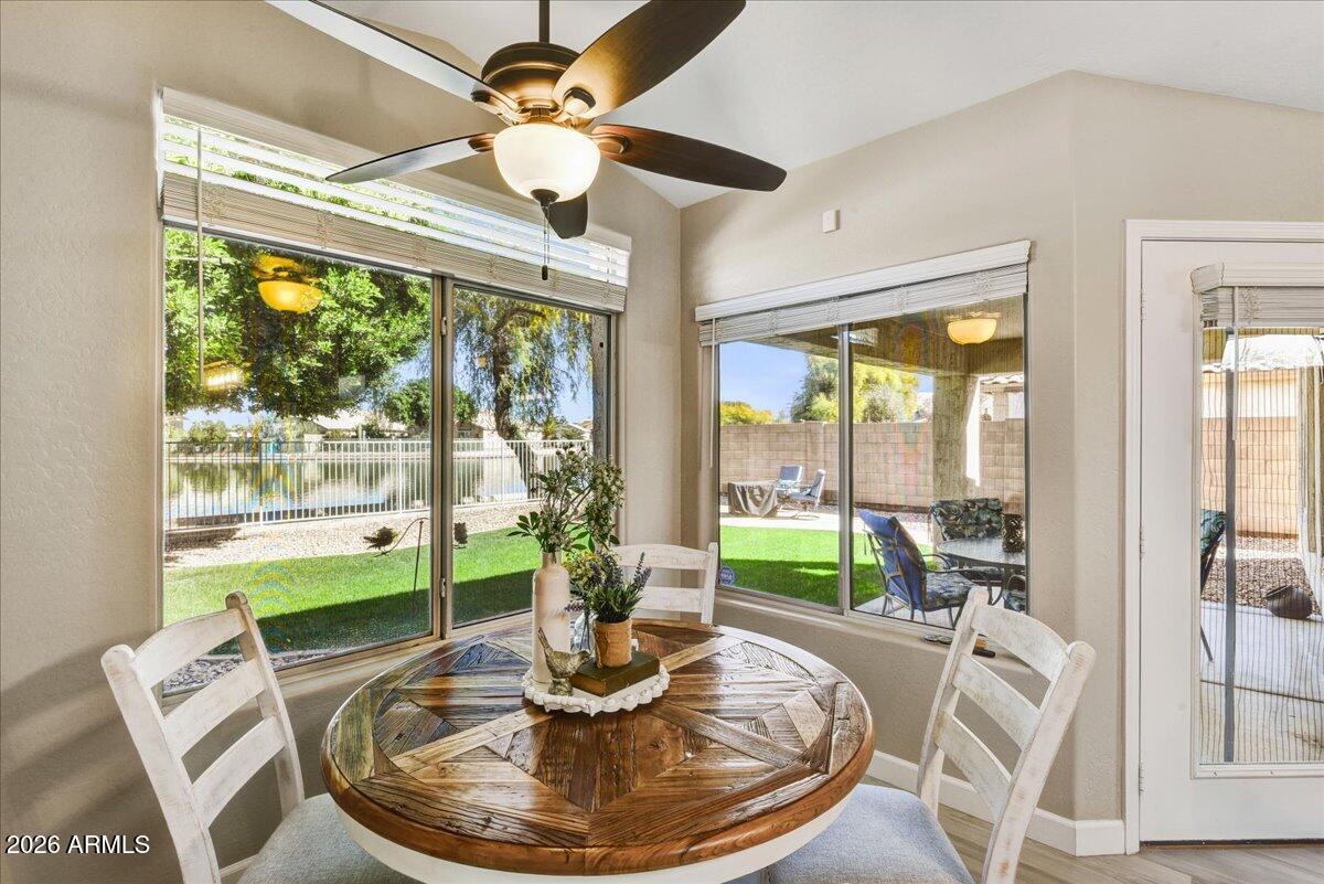 10830 West Almeria Road Avondale, AZ 85392 - Photo 15 of 27 a dining room with furniture a large window and a livingroom