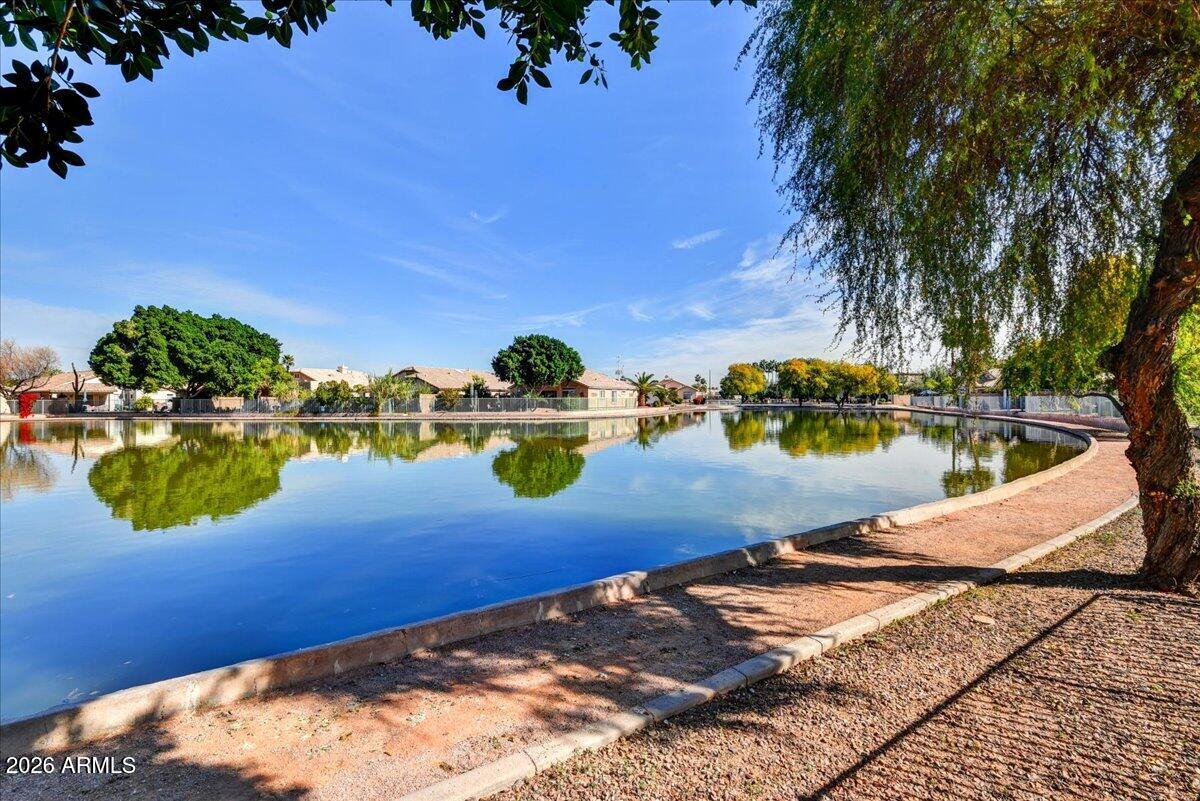 10830 West Almeria Road Avondale, AZ 85392 - Photo 18 of 27 a view of a lake with a car parked