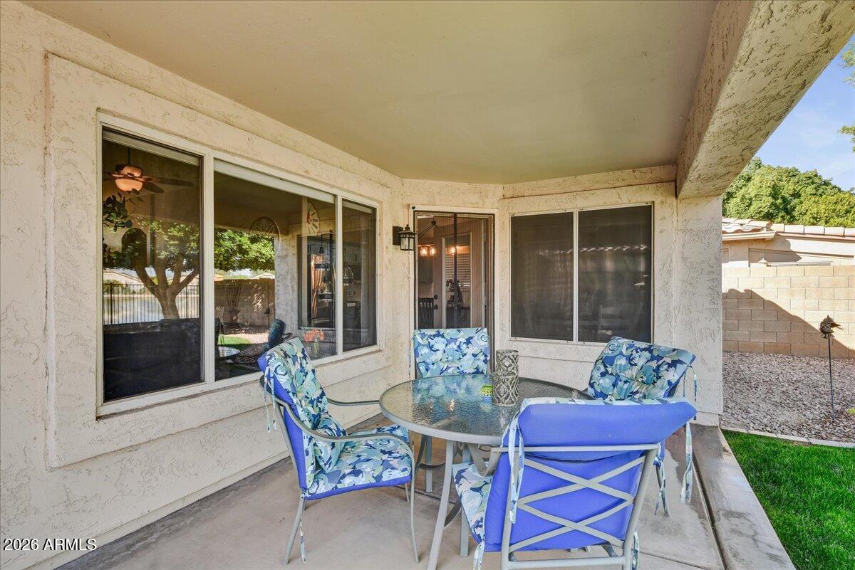 10830 West Almeria Road Avondale, AZ 85392 - Photo 19 of 27 a dining room with furniture wooden floor and a potted plant