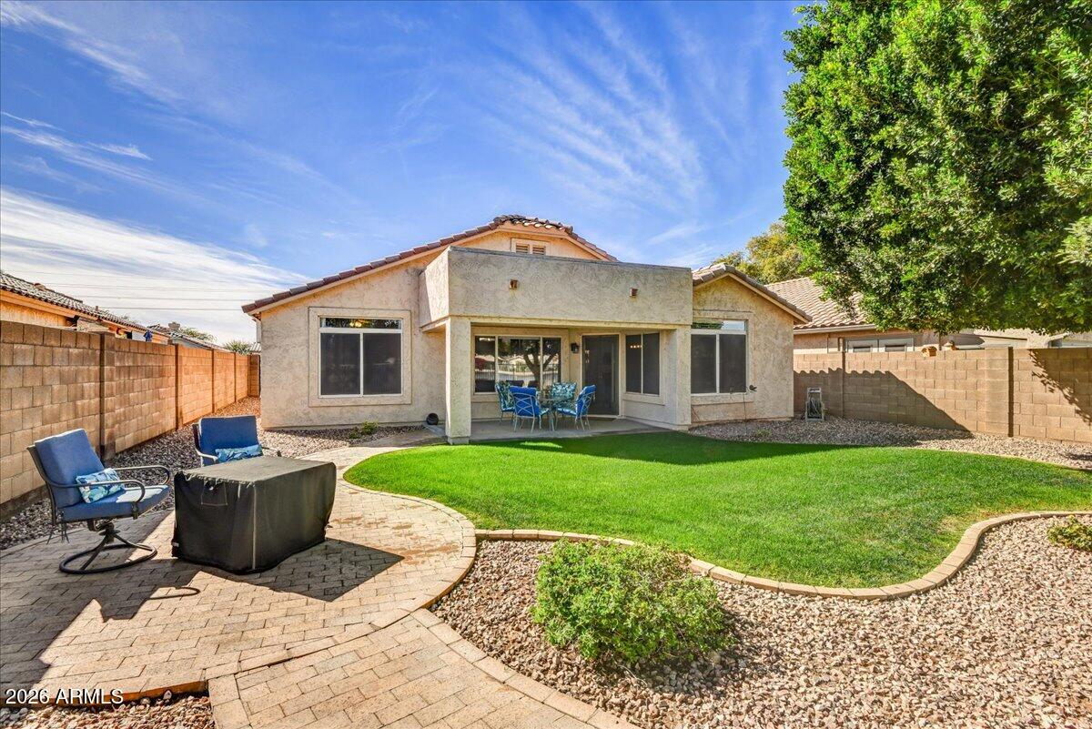 10830 West Almeria Road Avondale, AZ 85392 - Photo 22 of 27 a view of a house with backyard sitting area and garden