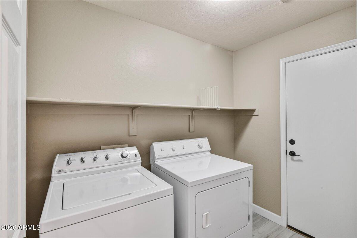 10830 West Almeria Road Avondale, AZ 85392 - Photo 25 of 27 a utility room with dryer and washer