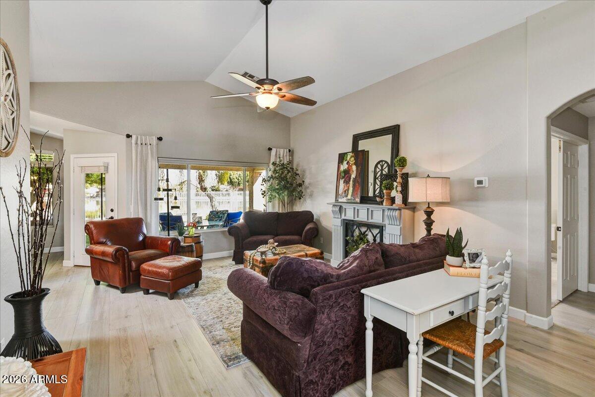 10830 West Almeria Road Avondale, AZ 85392 - Photo 4 of 27 a living room with furniture a ceiling fan and a window