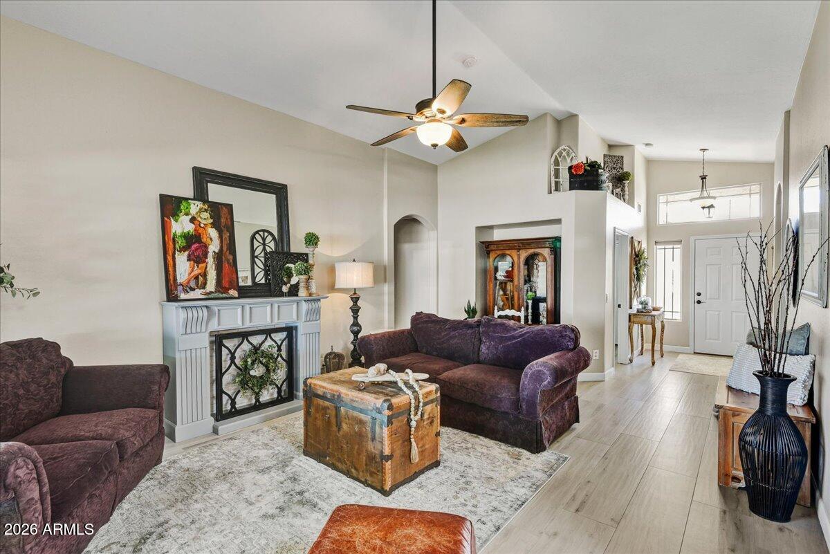 10830 West Almeria Road Avondale, AZ 85392 - Photo 5 of 27 a living room with furniture and a fireplace