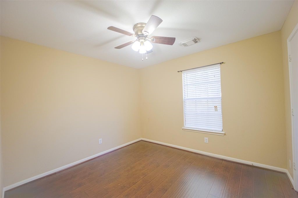 9611 Prairie Dog Run Sugar Land, TX 77498 - Photo 11 of 12 an empty room with windows and fan