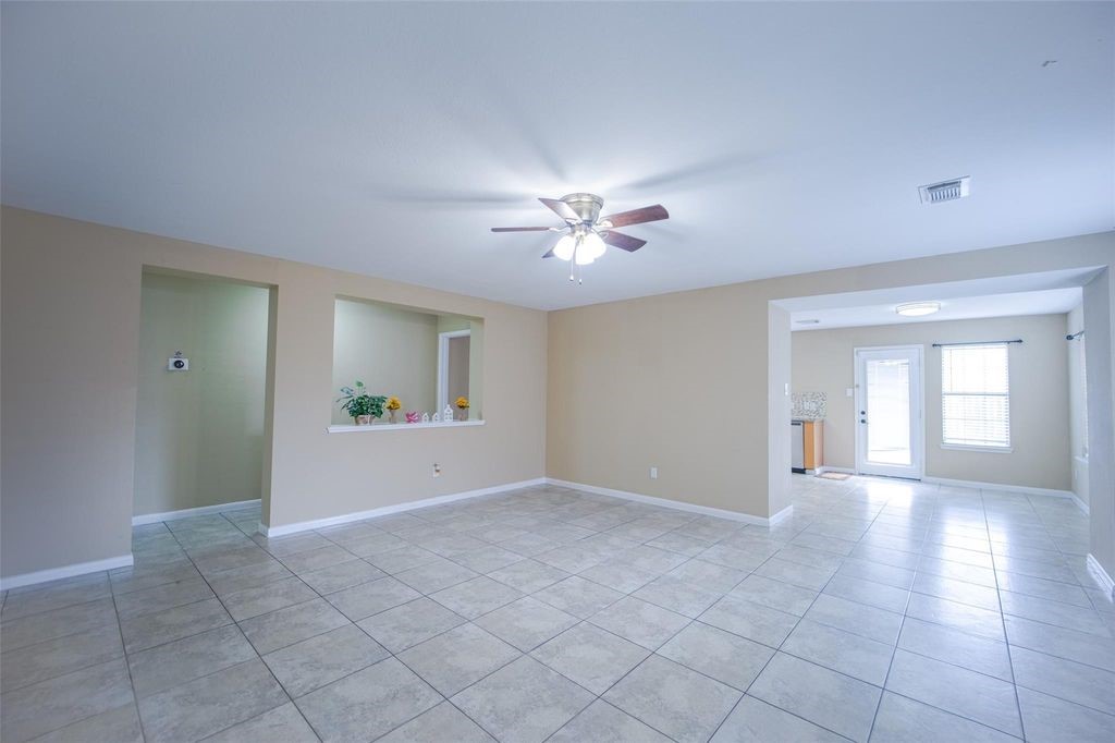 9611 Prairie Dog Run Sugar Land, TX 77498 - Photo 2 of 12 a view of an empty room with a window