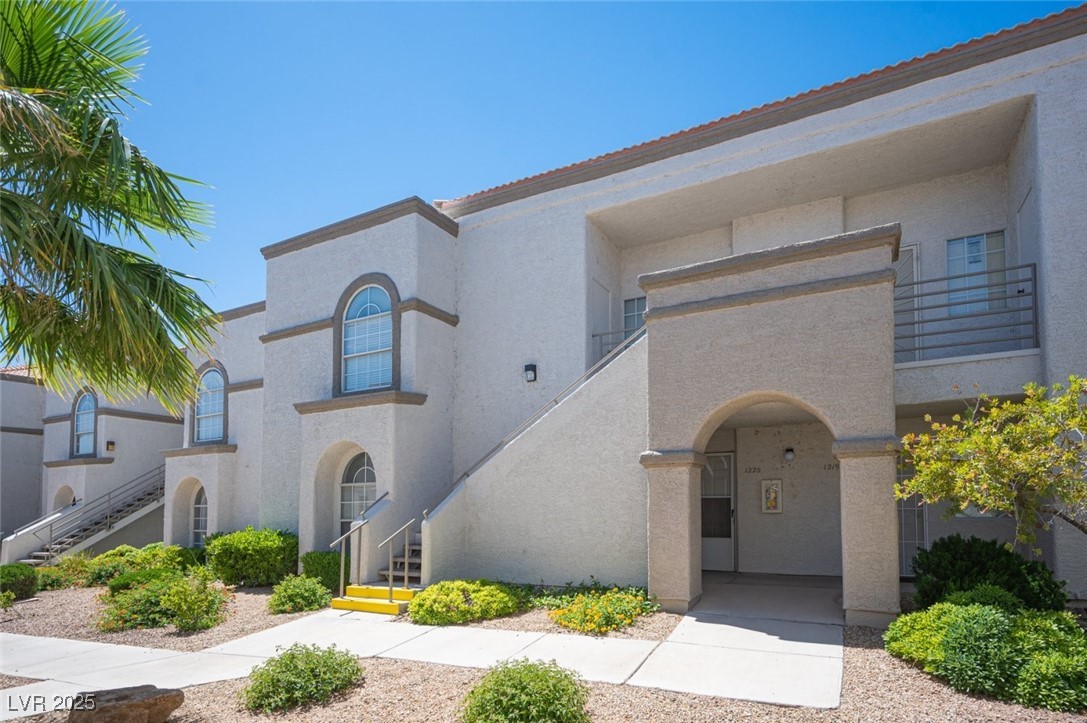 Mediterranean / spanish house featuring stucco siding and stairway