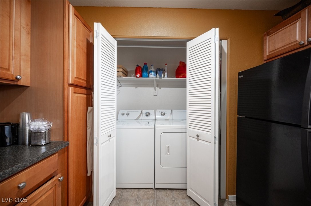 3150 North Soft Breezes Drive, Unit 2220 Las Vegas, NV 89128 - Photo 16 of 32 Washroom featuring washing machine and clothes dryer and light tile patterned floors