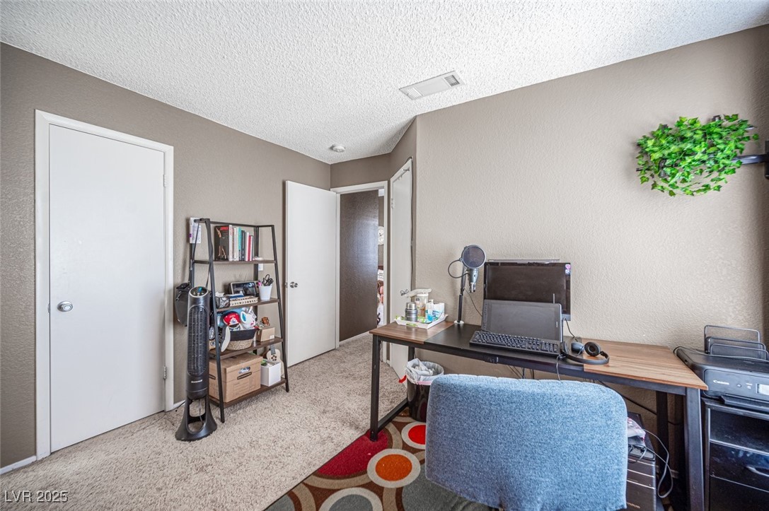 3150 North Soft Breezes Drive, Unit 2220 Las Vegas, NV 89128 - Photo 23 of 32 Office with a textured ceiling, a textured wall, and carpet