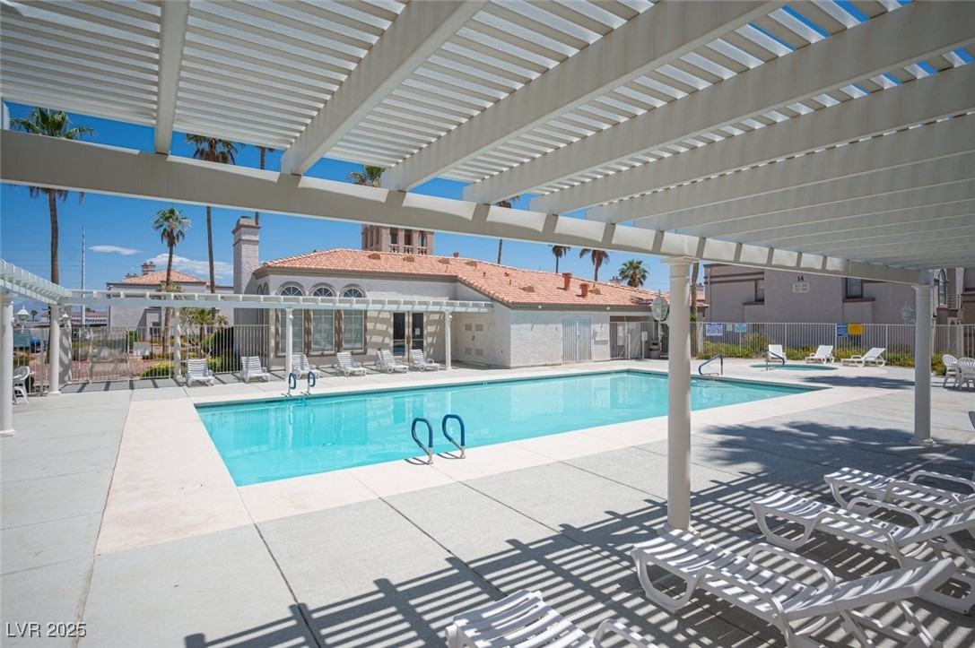 3150 North Soft Breezes Drive, Unit 2220 Las Vegas, NV 89128 - Photo 30 of 32 Community pool with a patio and a pergola