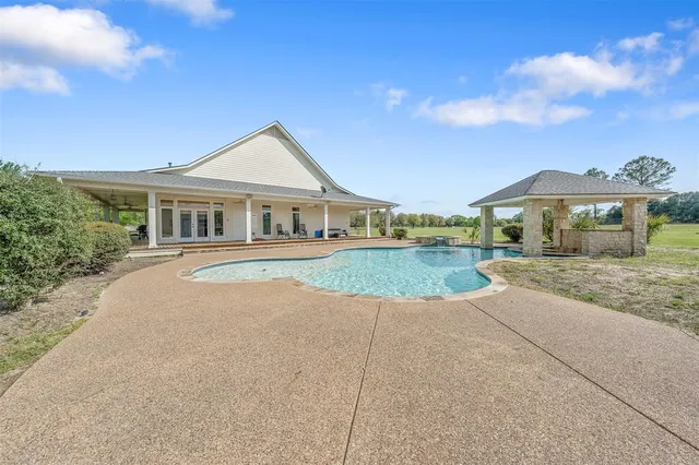 a view of a swimming pool with a patio