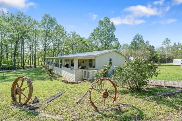 a backyard of a house with table and chairs