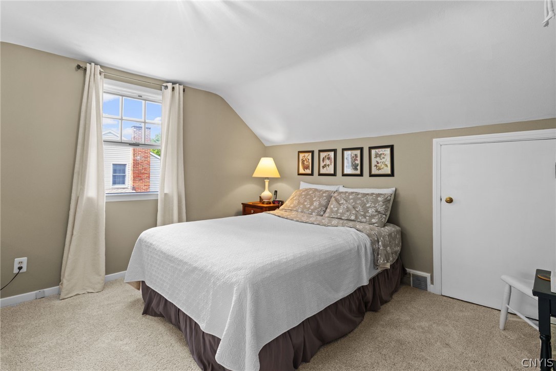 410 Meadow Road Geddes, NY 13219 - Photo 25 of 50 Bedroom with new carpets and a door that opens to the crawl space that is finished.