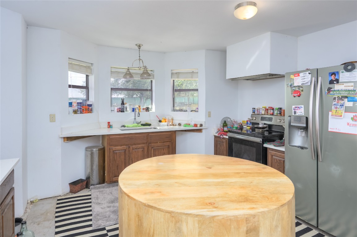 368 Lytton Lane Dale, TX 78616 - Photo 14 of 29 a kitchen with kitchen island a sink stainless steel appliances cabinets and a counter top space