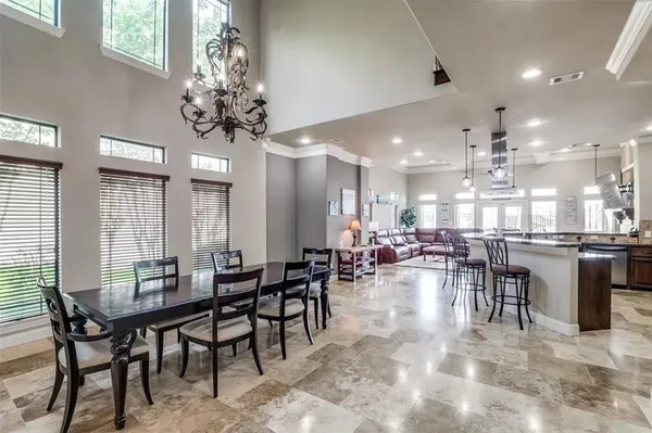 a large kitchen with a table and chairs