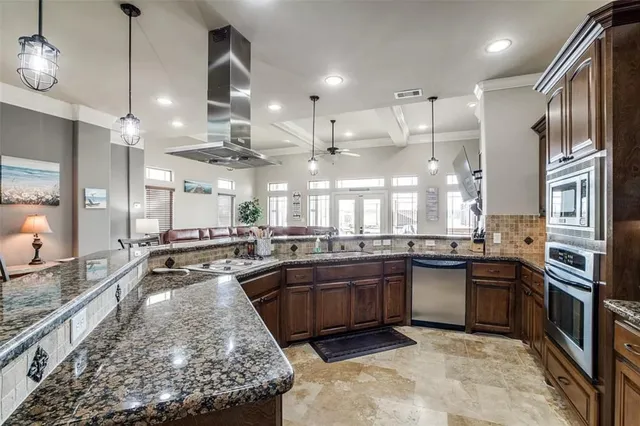 a large kitchen with lots of counter space and stainless steel appliances
