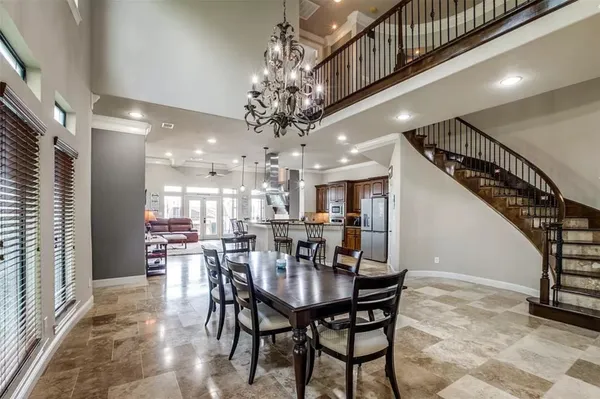 a view of a dining room with furniture and a chandelier