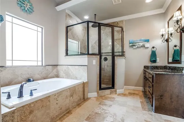 a bathroom with a tub a sink and a mirror