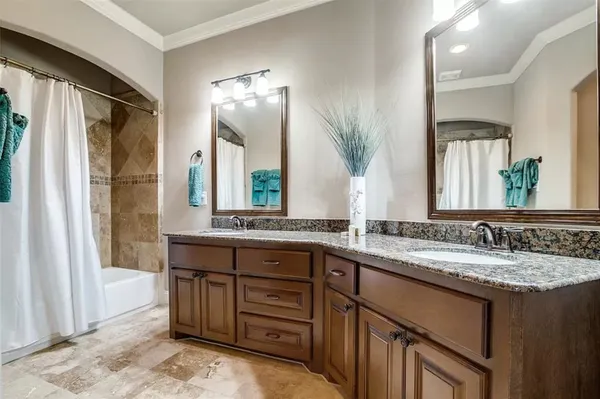 a bathroom with a granite countertop sink double vanity and a mirror