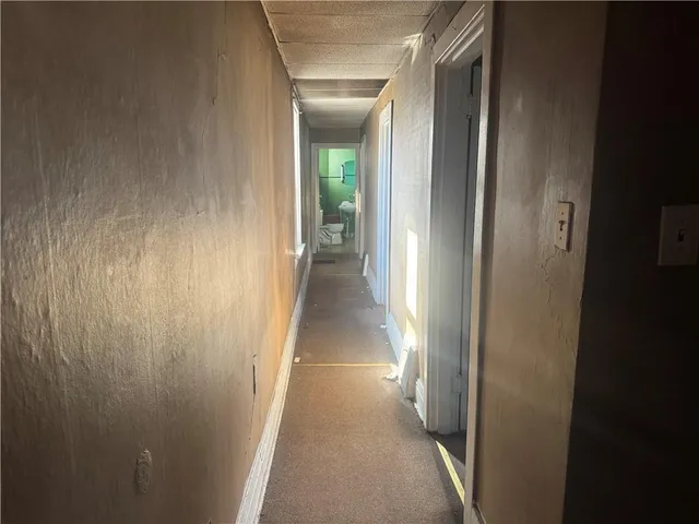a view of a hallway with a wooden door