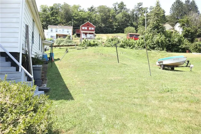 a view of swimming pool with sitting area and garden