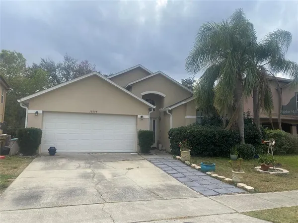a house with a yard and a large parking space