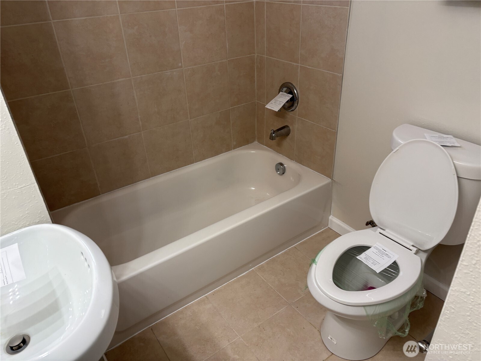 16312 127th Place Southeast Renton, WA 98058 - Photo 20 of 25 a white toilet sitting next to a bath tub