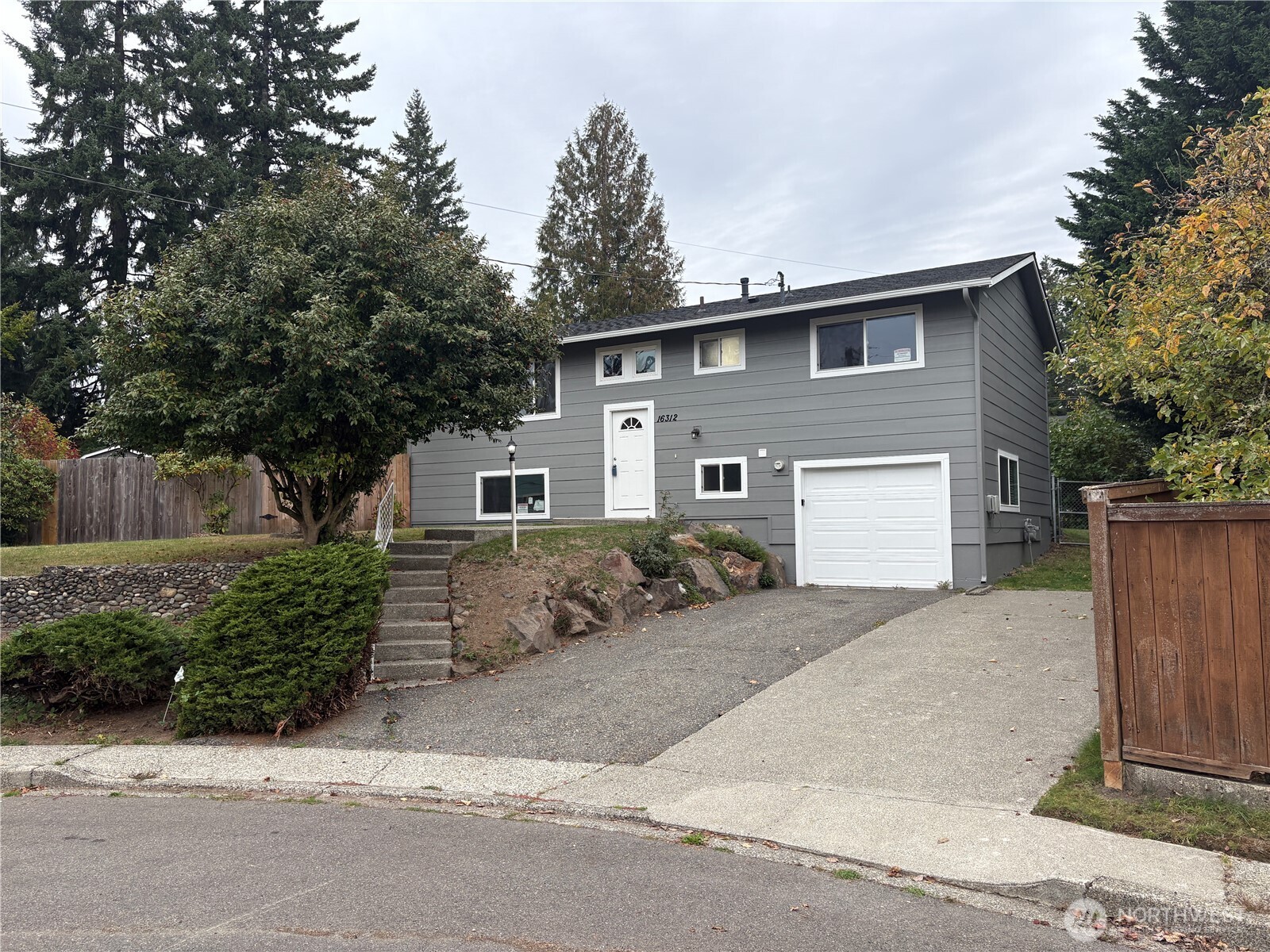 16312 127th Place Southeast Renton, WA 98058 - Photo 25 of 25 a front view of a house with a yard and garage