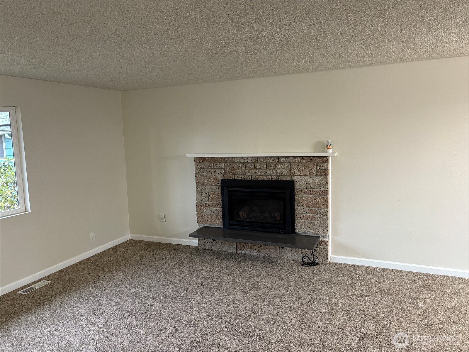 16312 127th Place Southeast Renton, WA 98058 - Photo 6 of 25 an empty room with a fireplace